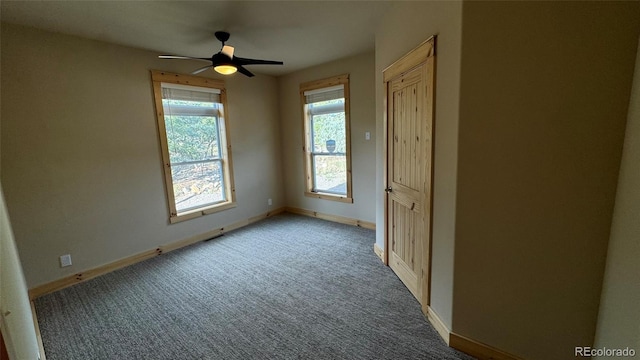 spare room with baseboards, a ceiling fan, and carpet flooring