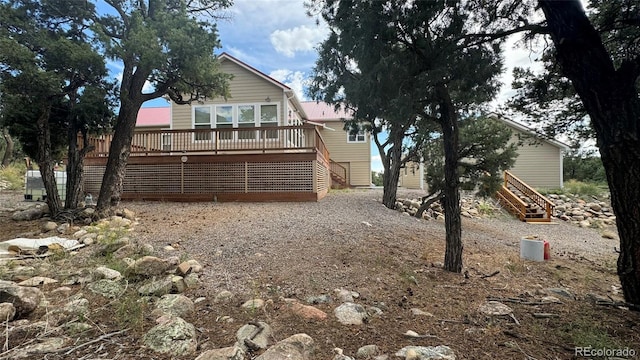 back of property featuring a wooden deck