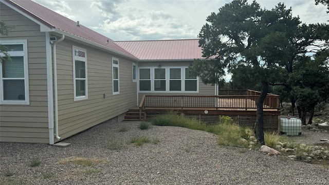 view of side of home with a wooden deck