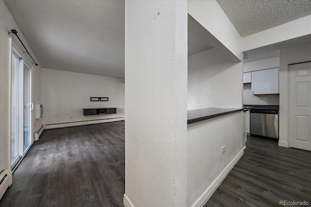 corridor with dark wood-style floors, baseboard heating, and a textured ceiling