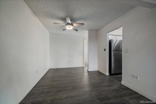 spare room featuring dark wood-style floors, baseboards, a ceiling fan, and a textured ceiling