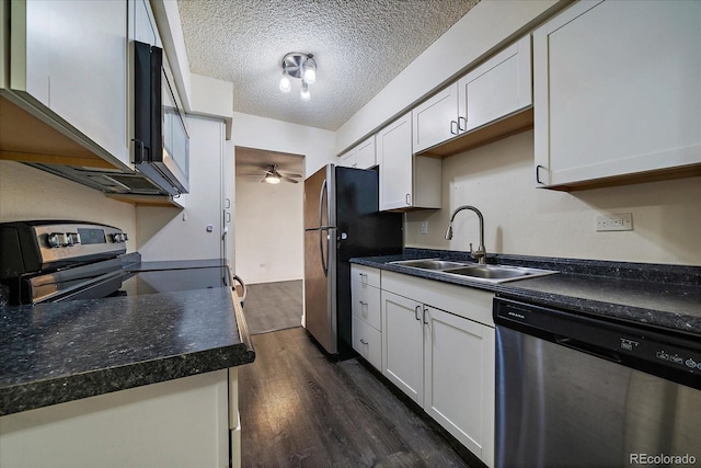 kitchen featuring dark wood-style flooring, appliances with stainless steel finishes, a sink, a textured ceiling, and ceiling fan