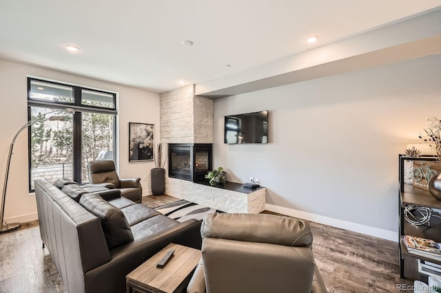 930 Blue River Pkwy Unit 812, Silverthorne, CO 80498 - living area featuring baseboards, recessed lighting, a multi sided fireplace, and wood finished floors