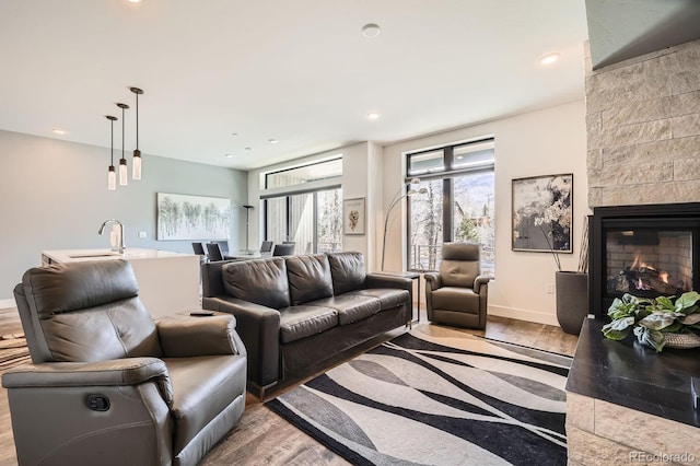 930 Blue River Pkwy Unit 812, Silverthorne, CO 80498 - living area featuring recessed lighting, wood finished floors, and a fireplace