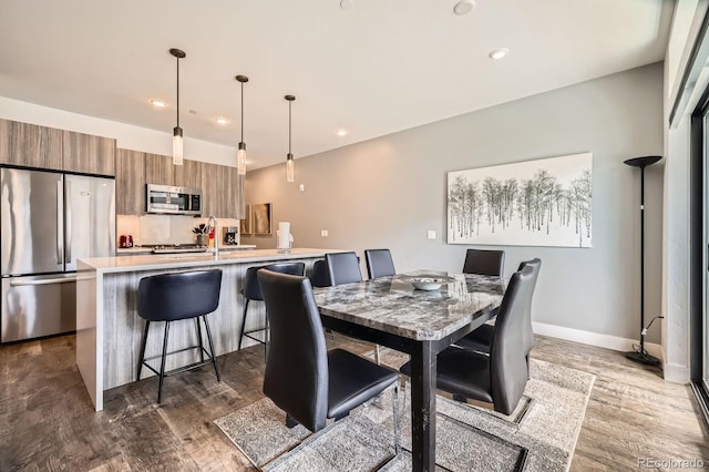 930 Blue River Pkwy Unit 812, Silverthorne, CO 80498 - dining room with recessed lighting, baseboards, and dark wood-style flooring