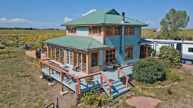 rear view of property featuring a rural view and a wooden deck