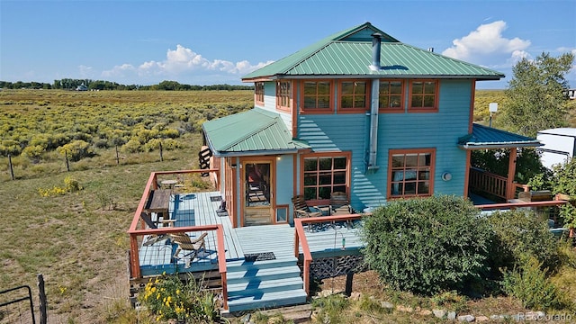 view of front facade featuring a deck and a rural view