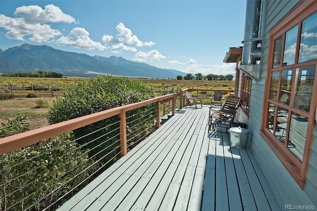 wooden terrace with a mountain view and a rural view