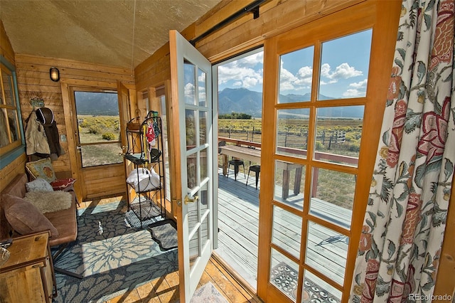 sunroom / solarium featuring a wealth of natural light and a mountain view