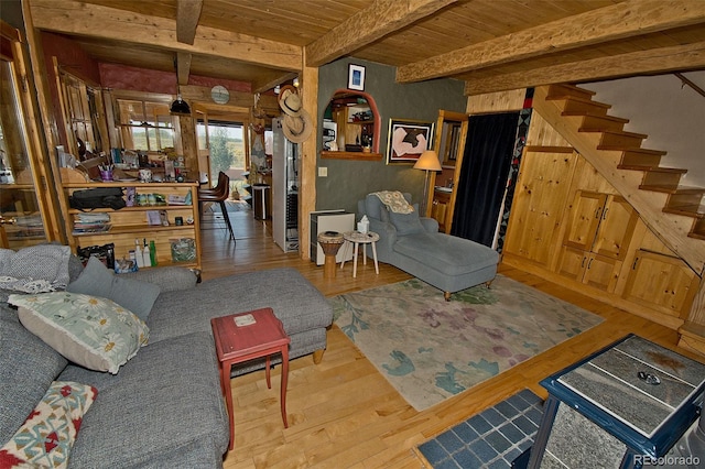 living room featuring wooden ceiling, beamed ceiling, hardwood / wood-style flooring, and wooden walls