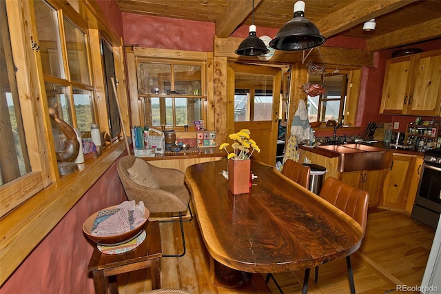 dining space with light hardwood / wood-style flooring, sink, beamed ceiling, and wooden ceiling