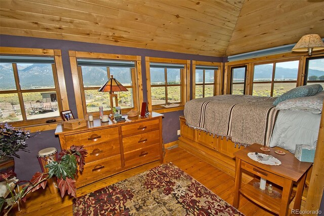 bedroom featuring wooden ceiling, multiple windows, lofted ceiling, and hardwood / wood-style flooring