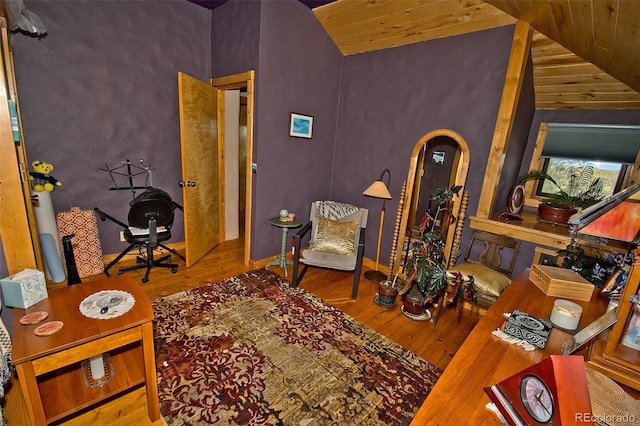 interior space featuring high vaulted ceiling, hardwood / wood-style flooring, and wooden ceiling