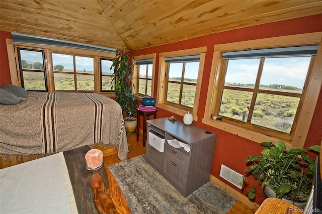 bedroom featuring vaulted ceiling, multiple windows, hardwood / wood-style flooring, and wood ceiling