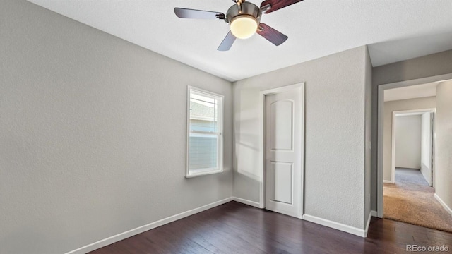 unfurnished bedroom with dark hardwood / wood-style flooring and ceiling fan