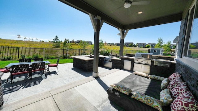 view of patio / terrace featuring an outdoor kitchen, area for grilling, and ceiling fan