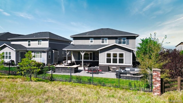 back of house featuring an outdoor hangout area, a yard, and a patio area