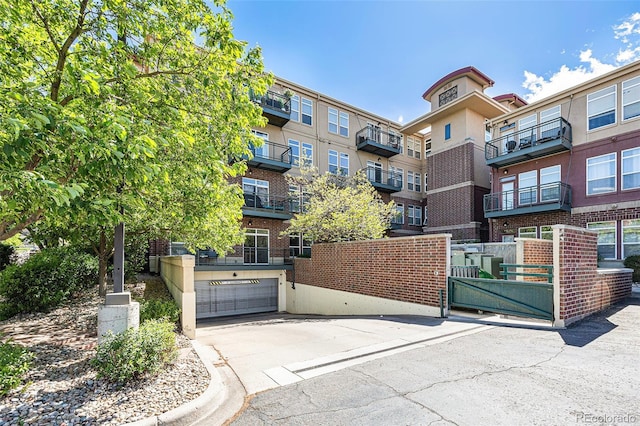 10184 Park Meadows Dr Unit 1102, Lone Tree, CO 80124 - view of apartment building / complex featuring a garage and concrete driveway