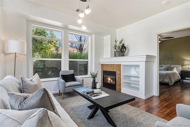 10184 Park Meadows Dr Unit 1102, Lone Tree, CO 80124 - living room featuring wood finished floors, a fireplace, built in shelves, and baseboards