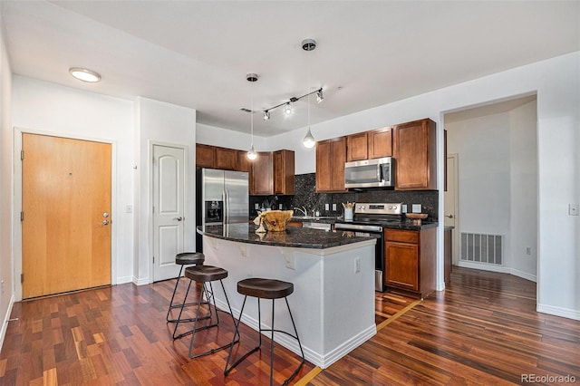 10184 Park Meadows Dr Unit 1102, Lone Tree, CO 80124 - kitchen featuring stainless steel appliances, dark wood-style floors, a breakfast bar area, and backsplash