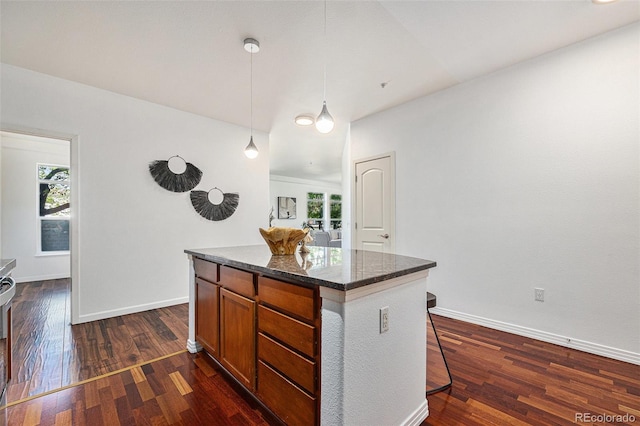 10184 Park Meadows Dr Unit 1102, Lone Tree, CO 80124 - kitchen featuring plenty of natural light, dark wood-style flooring, a kitchen island, and decorative light fixtures