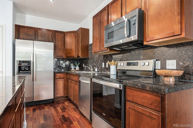 10184 Park Meadows Dr Unit 1102, Lone Tree, CO 80124 - kitchen with stainless steel appliances, dark wood-type flooring, a sink, dark stone counters, and backsplash