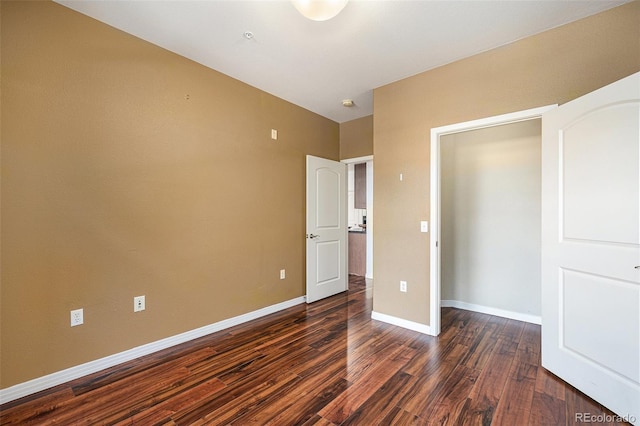 10184 Park Meadows Dr Unit 1102, Lone Tree, CO 80124 - unfurnished bedroom with dark wood-style flooring and baseboards