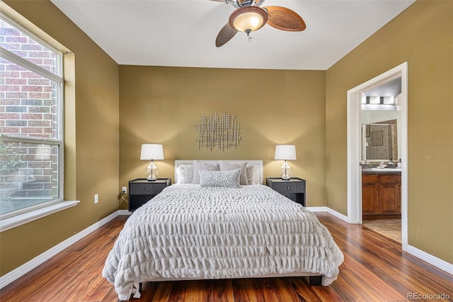 10184 Park Meadows Dr Unit 1102, Lone Tree, CO 80124 - bedroom with wood finished floors, baseboards, connected bathroom, a sink, and ceiling fan