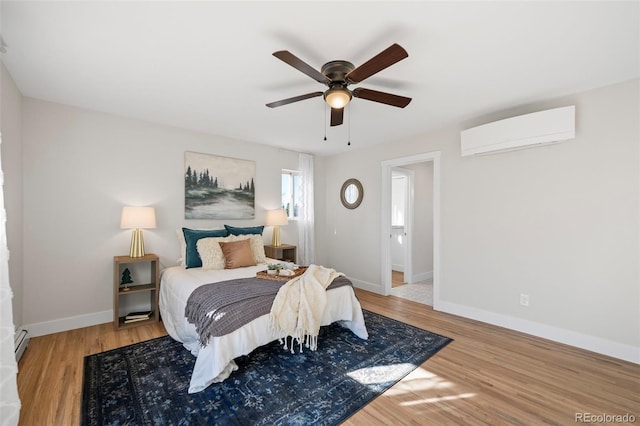 bedroom featuring an AC wall unit, ceiling fan, hardwood / wood-style floors, and a baseboard heating unit