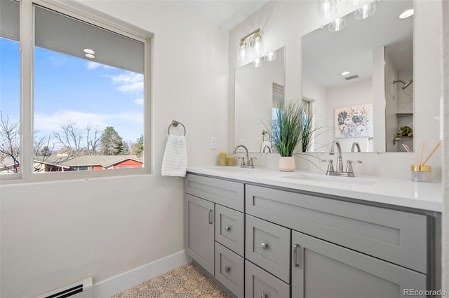 bathroom with vanity and a baseboard heating unit