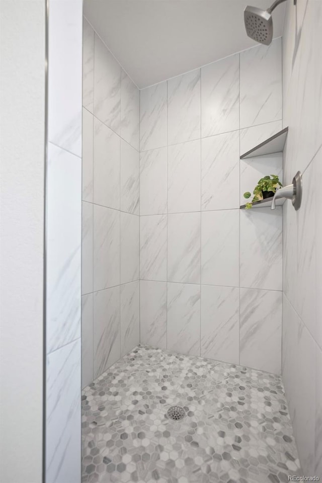 bathroom with tiled shower