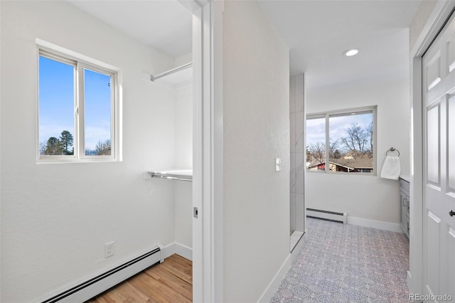 bathroom with a baseboard radiator and hardwood / wood-style flooring