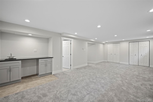 basement with light carpet and sink