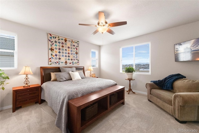 bedroom featuring ceiling fan and light carpet