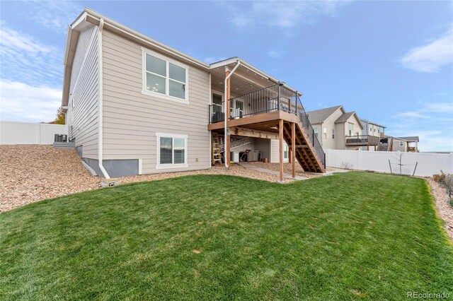 back of property featuring a yard and a deck