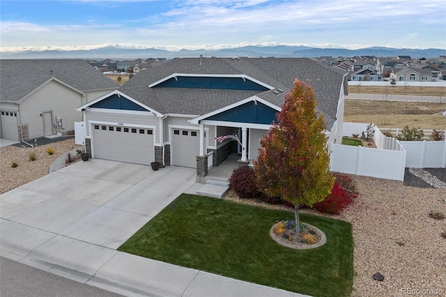 view of front of home with a mountain view, a garage, and a front yard