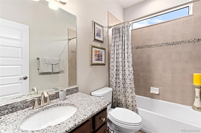 full bathroom featuring shower / tub combo with curtain, vanity, and toilet