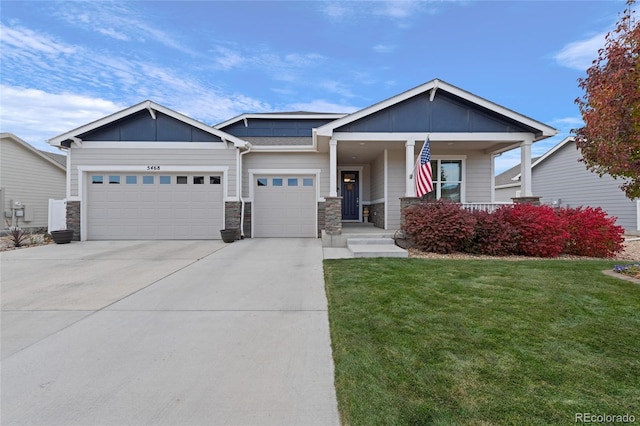 view of front of home with a garage, a porch, and a front lawn