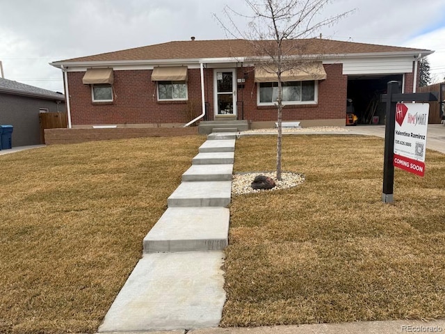 ranch-style house with brick siding, a front yard, driveway, and a garage