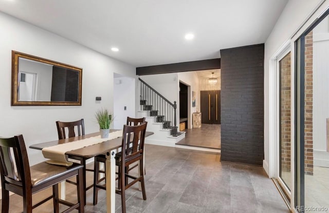 dining room featuring brick wall