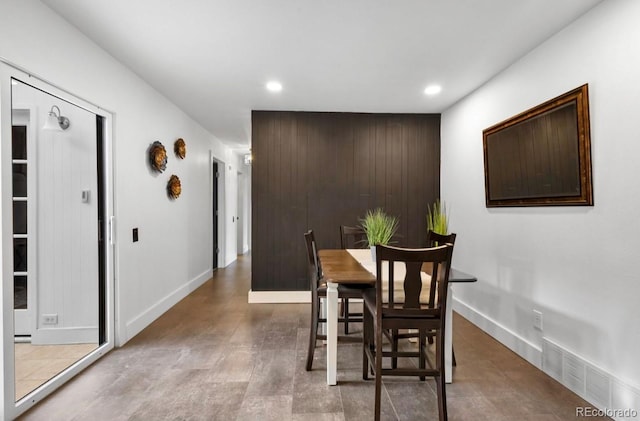 dining space with wooden walls