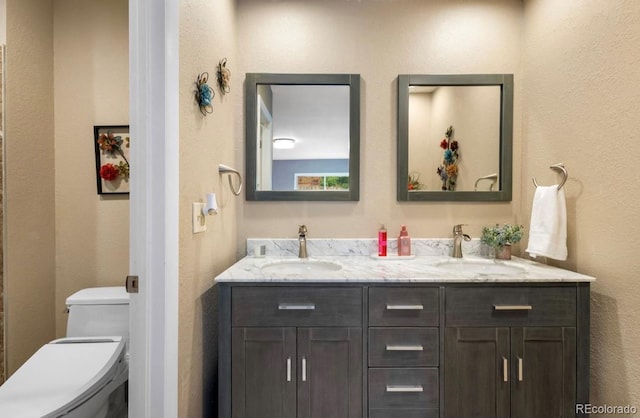 bathroom with toilet and vanity