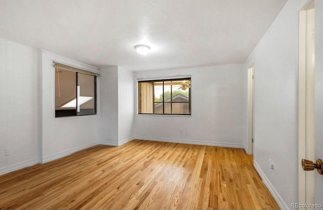 spare room featuring light hardwood / wood-style flooring