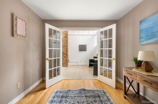 entryway with french doors and wood-type flooring