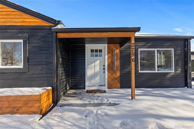 view of snow covered property entrance