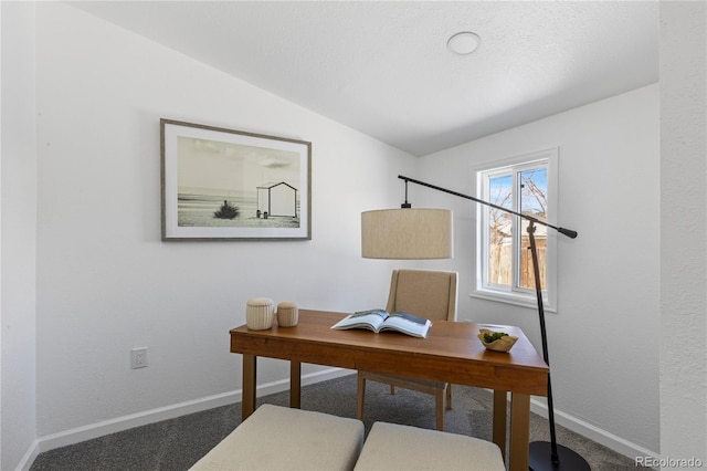 office featuring lofted ceiling, baseboards, dark carpet, and a textured ceiling