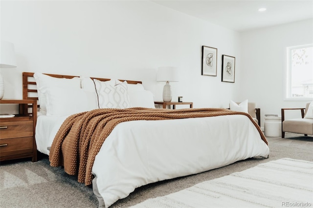 bedroom featuring light carpet and recessed lighting