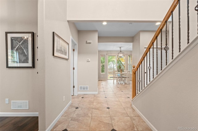 entryway featuring an inviting chandelier