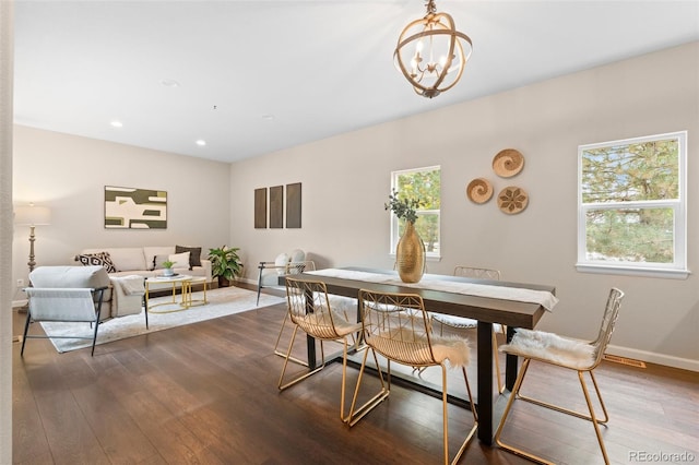 dining area featuring a chandelier and dark hardwood / wood-style flooring