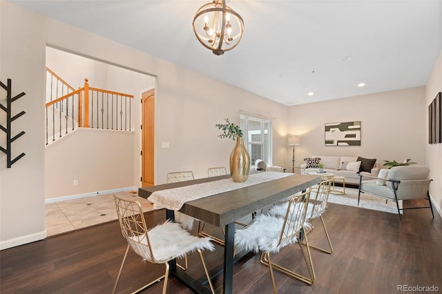 dining room featuring hardwood / wood-style flooring and an inviting chandelier